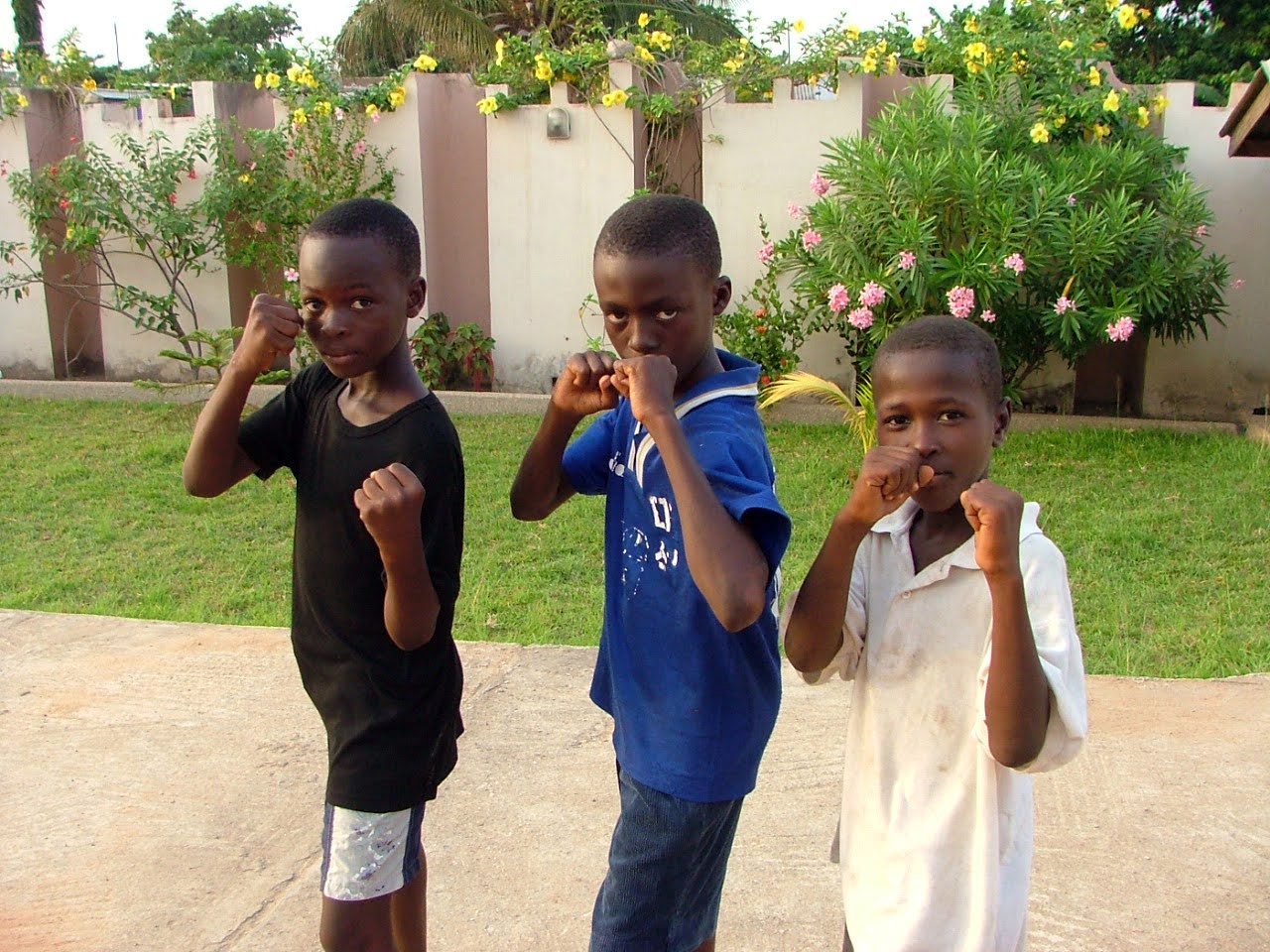 Three young Ghanaian boxing children showing fists